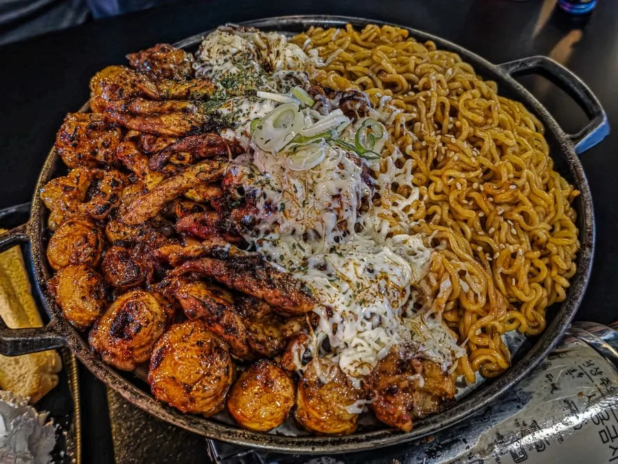 Maedalgu set with grilled beef intestine, chicken neck meat, and fire noodles