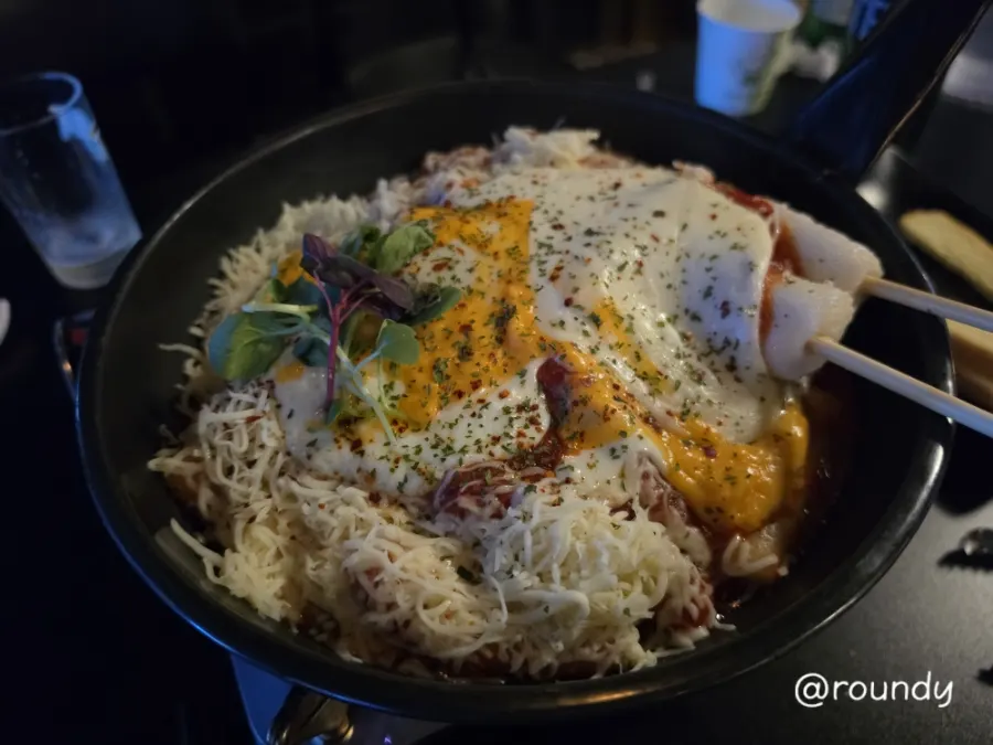 The tomato cheese waterfall boneless chicken thigh simmering on the burner
