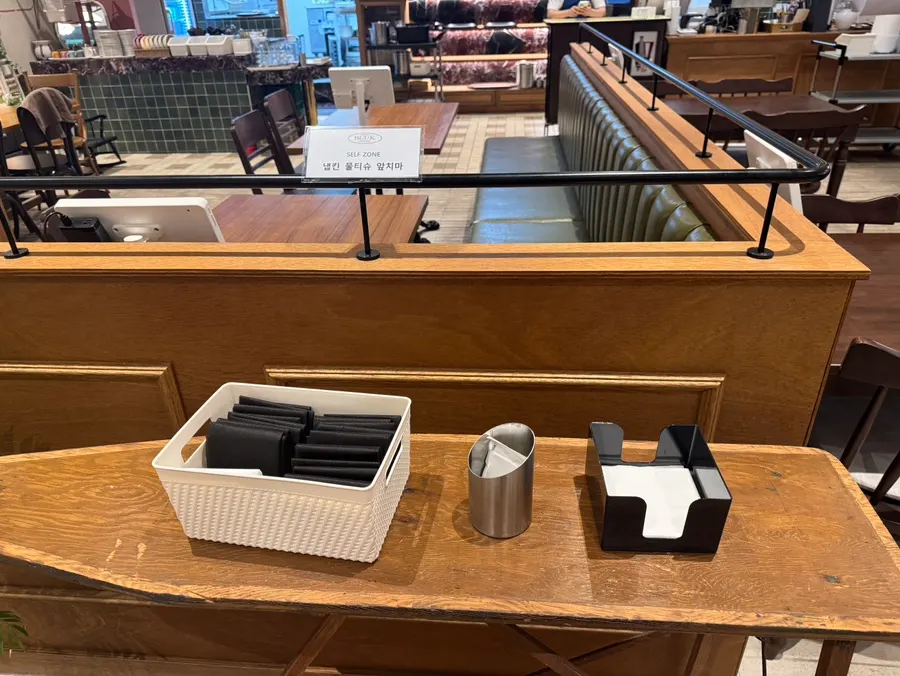 Self-serve corner with aprons, tissues, and wet wipes