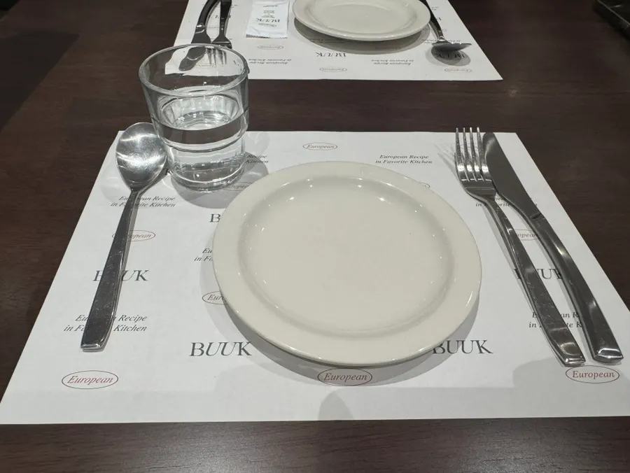 Table set with water, cutlery, and plates