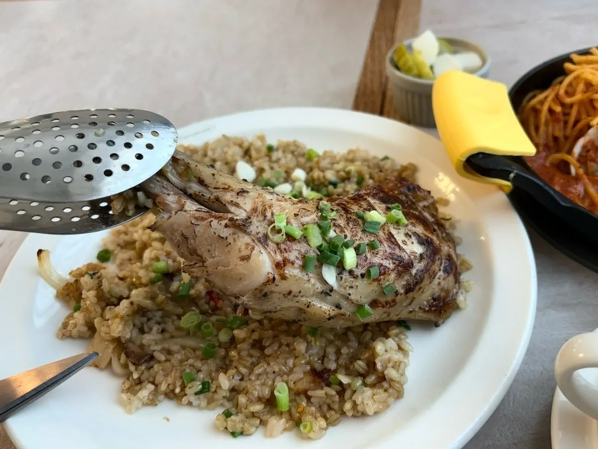 Kung pao chicken pilaf topped with a chicken leg