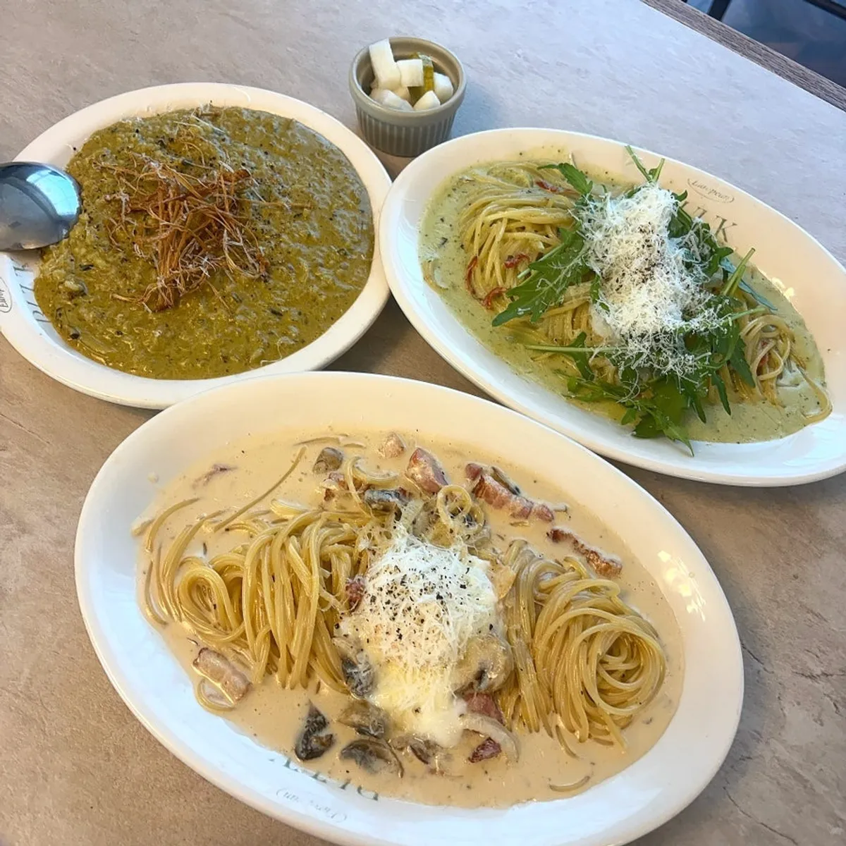 Table with three pasta and risotto dishes