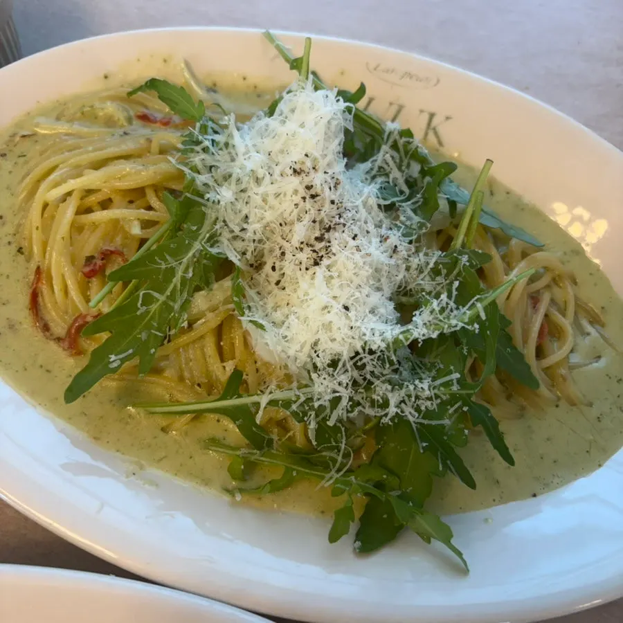 Close-up of cream pasta topped with a poached egg