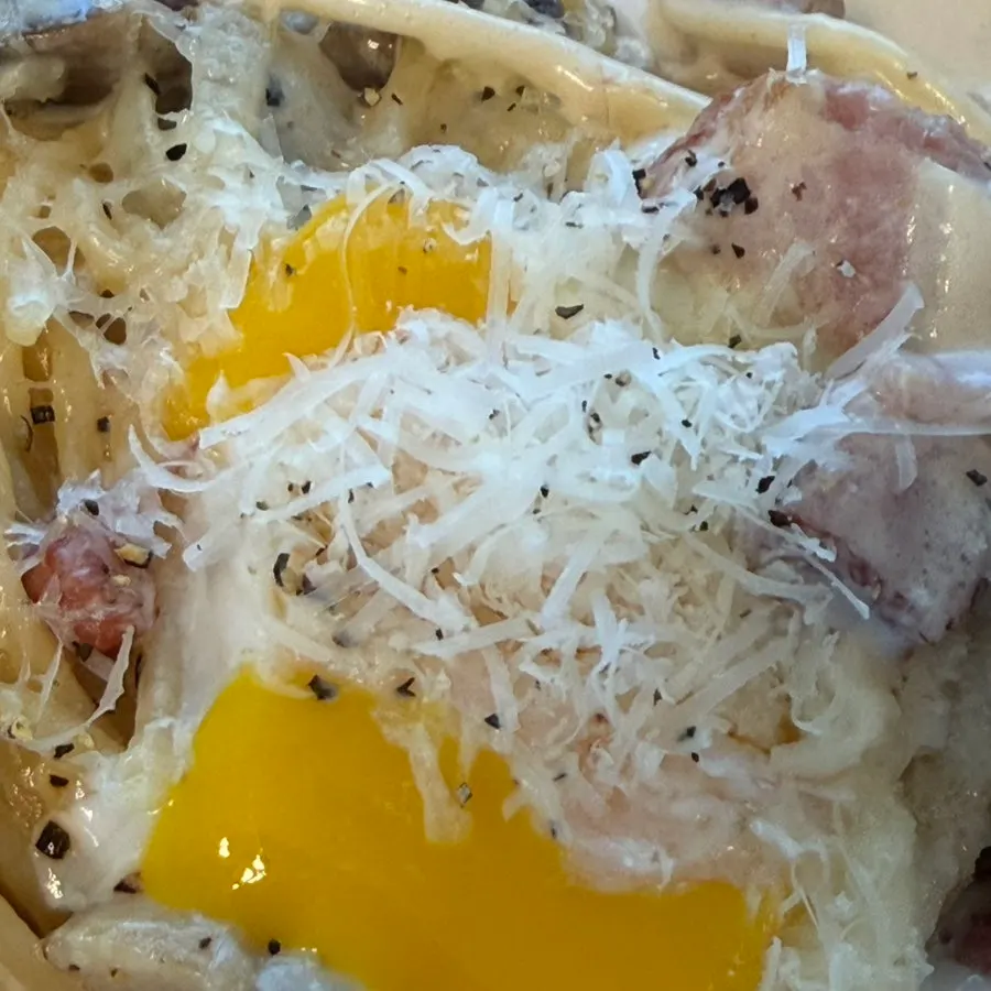 Cream pasta noodles lifted up on a fork