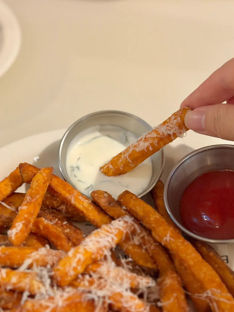 Sweet potato fries served with yogurt sauce and ketchup