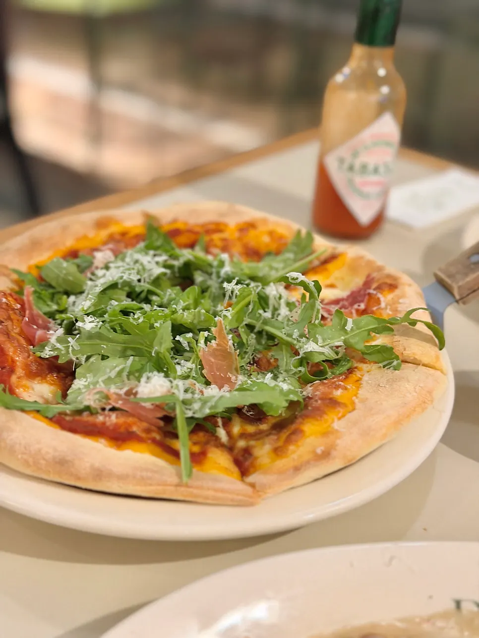 A whole arugula prosciutto pizza