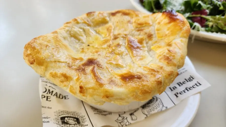 Pastry soup with pumpkin soup hidden inside