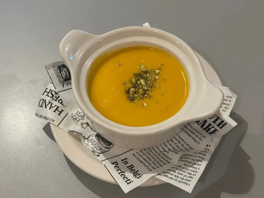 Bright yellow pumpkin soup