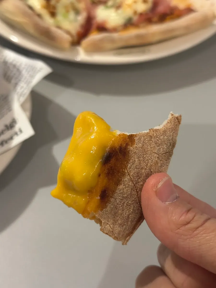Dipping a pizza crust into pumpkin soup