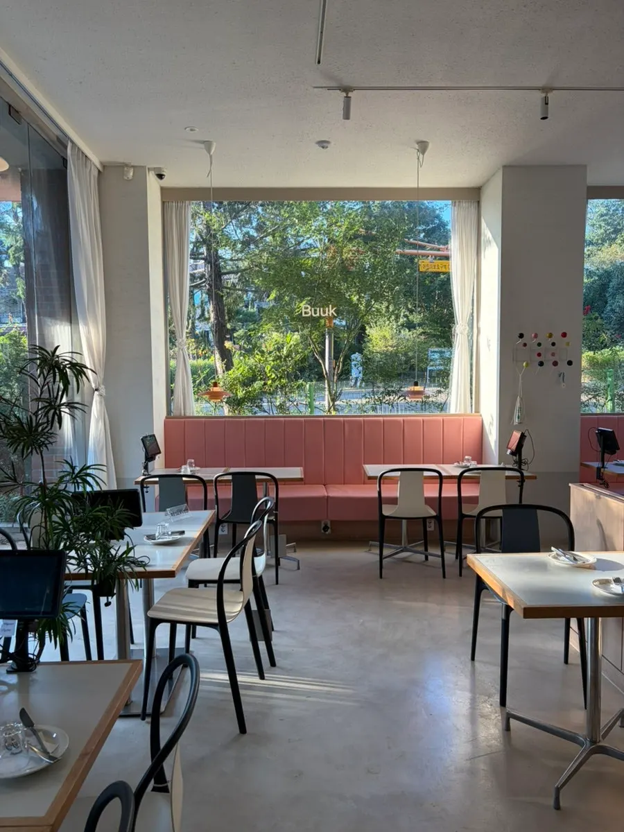 Seating by the floor-to-ceiling windows letting in light