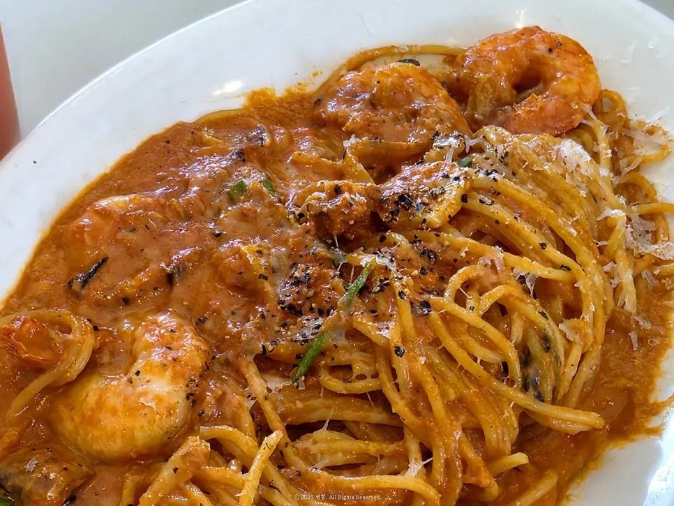 Close-up of the thick rosé sauce on the shrimp pasta