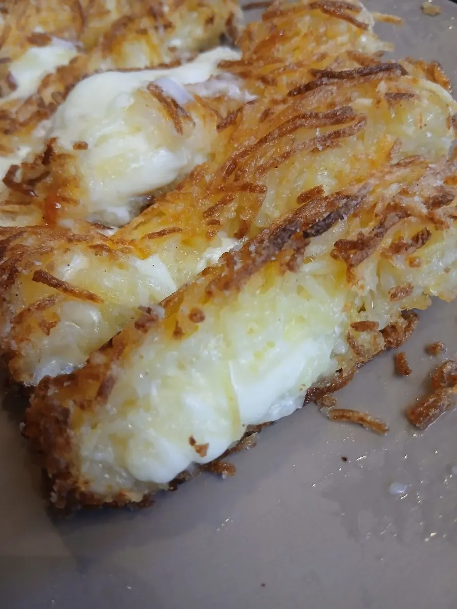 Close-up of the golden, crispy surface of the shredded potato pancake