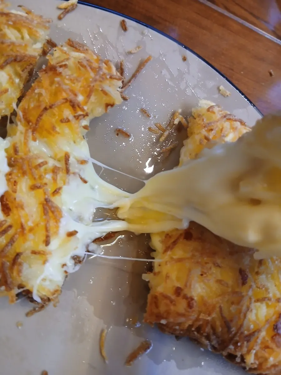 Soy sauce, ketchup, and green onion kimchi served with the cheese potato pancake