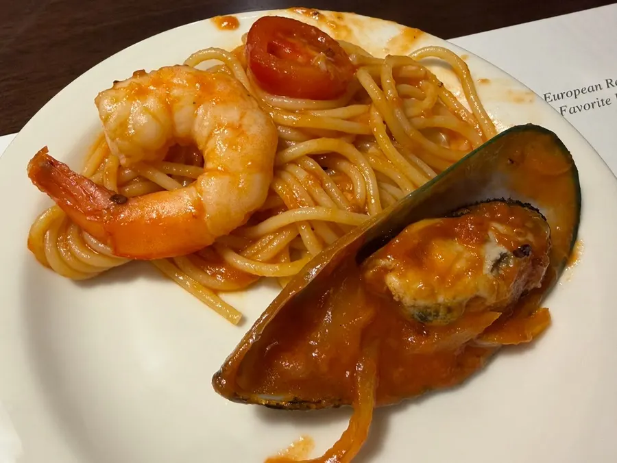 Seafood tomato pasta served at the family meal table