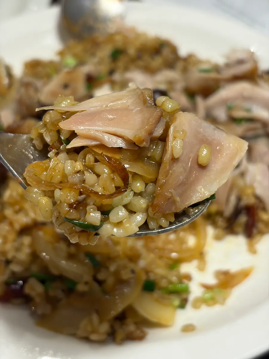 Whole chicken leg served on top of the pilaf