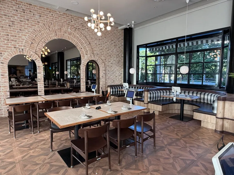 Arched mirror interior against a brick wall