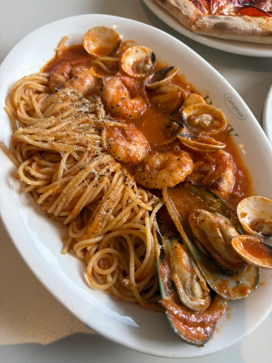 A plate of seafood tomato pasta