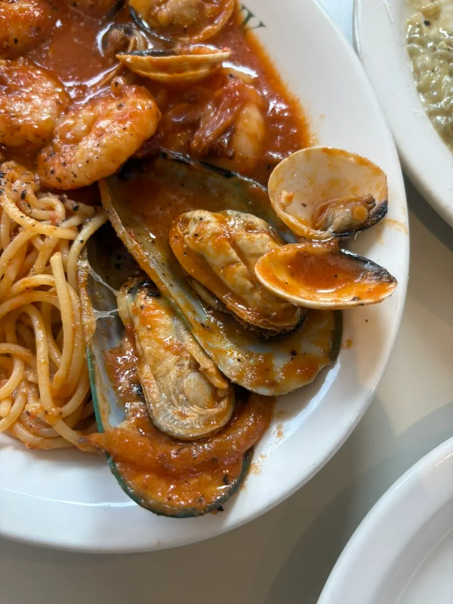 Seafood tomato pasta topped with shrimp and mussels
