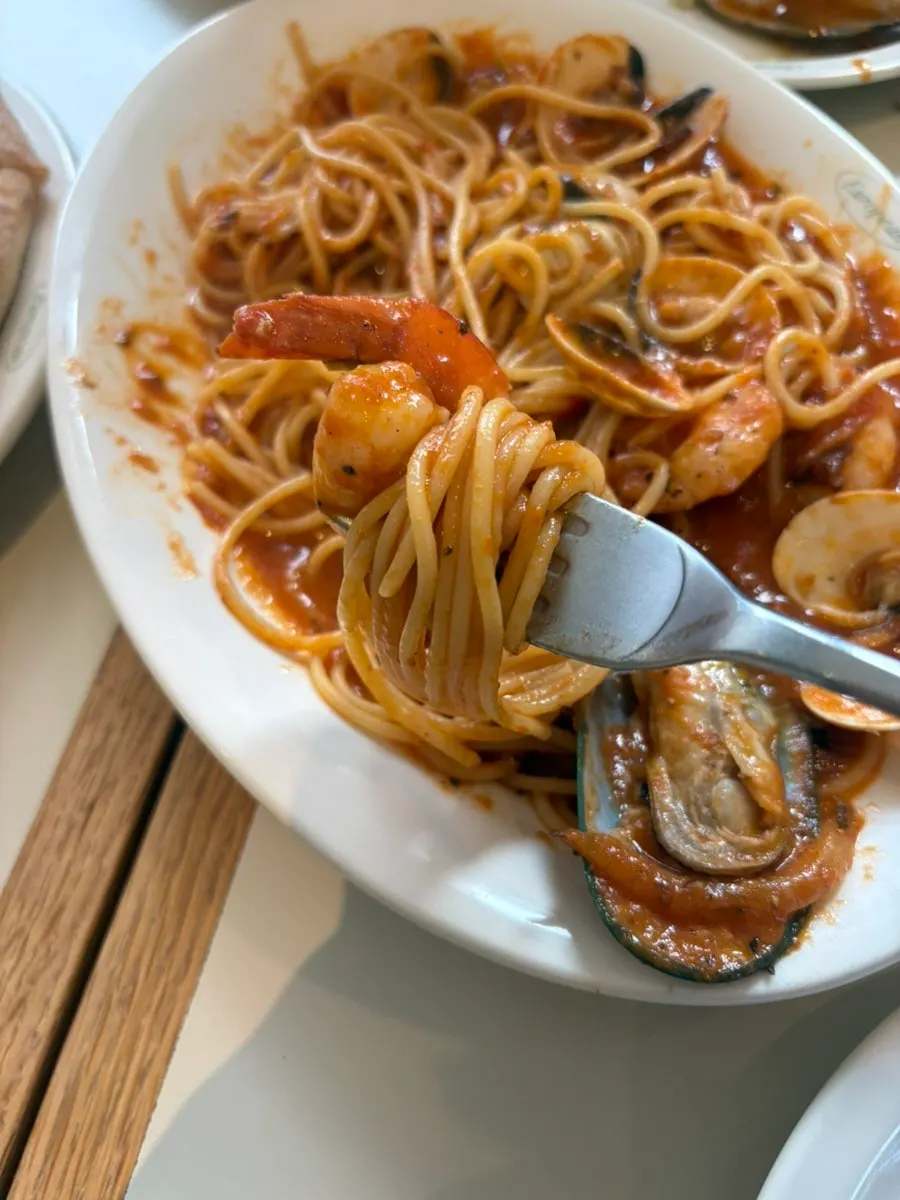 Pasta noodles coated in tomato sauce