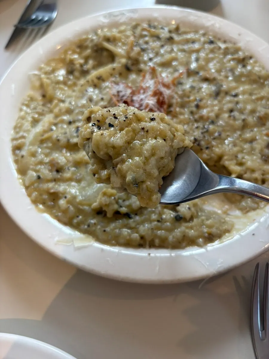 Abalone cream risotto topped with fried enoki mushrooms