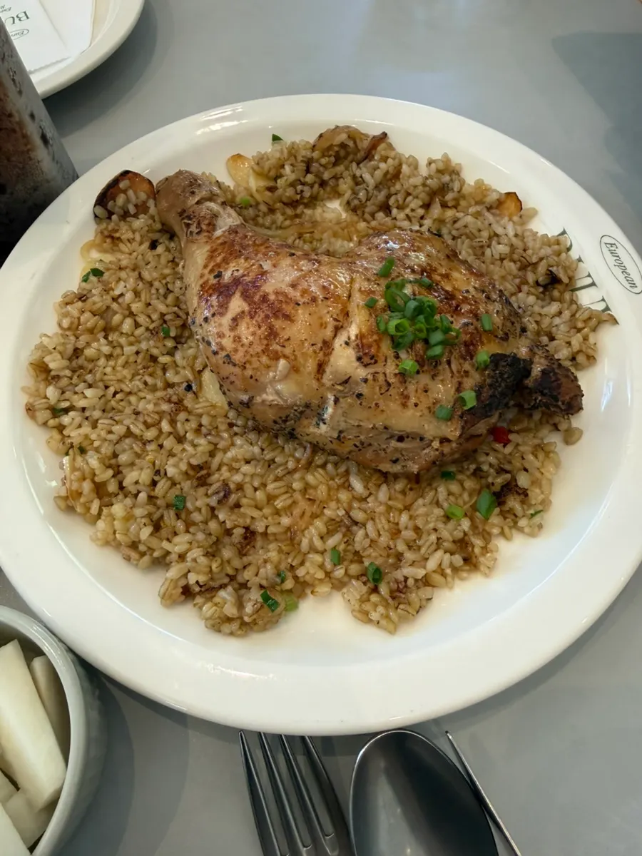 Kung Pao chicken pilaf topped with a large chicken leg