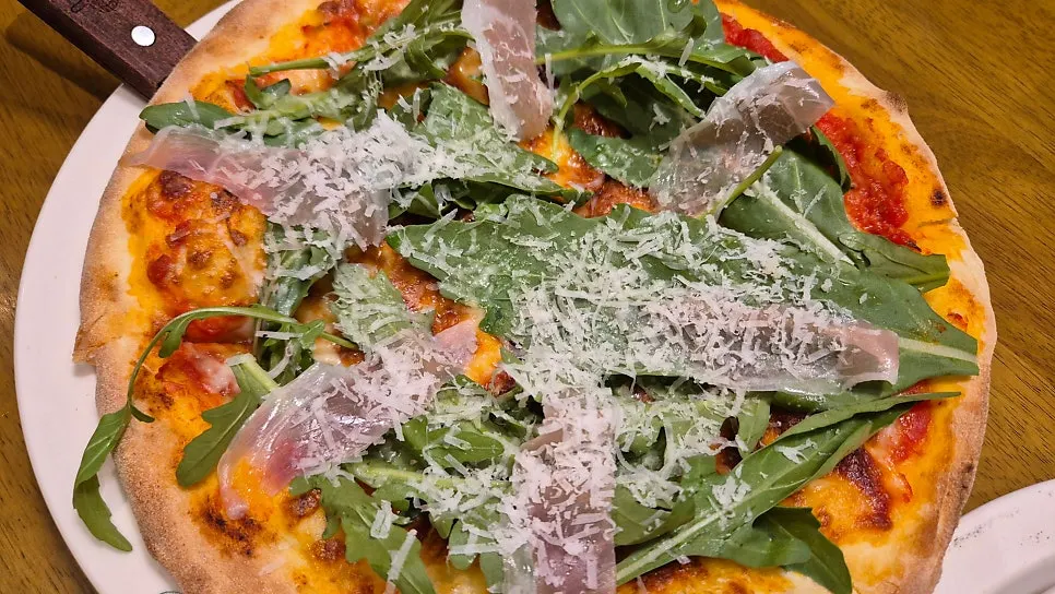 Rocket prosciutto pizza and lasagna served together
