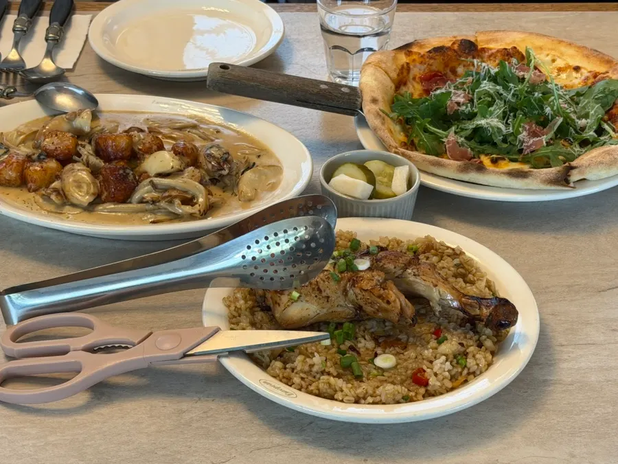 Table spread with gnocchi, pizza, and pilaf