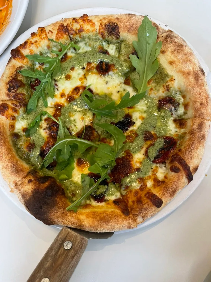 Basil margherita pizza topped with grilled tomatoes