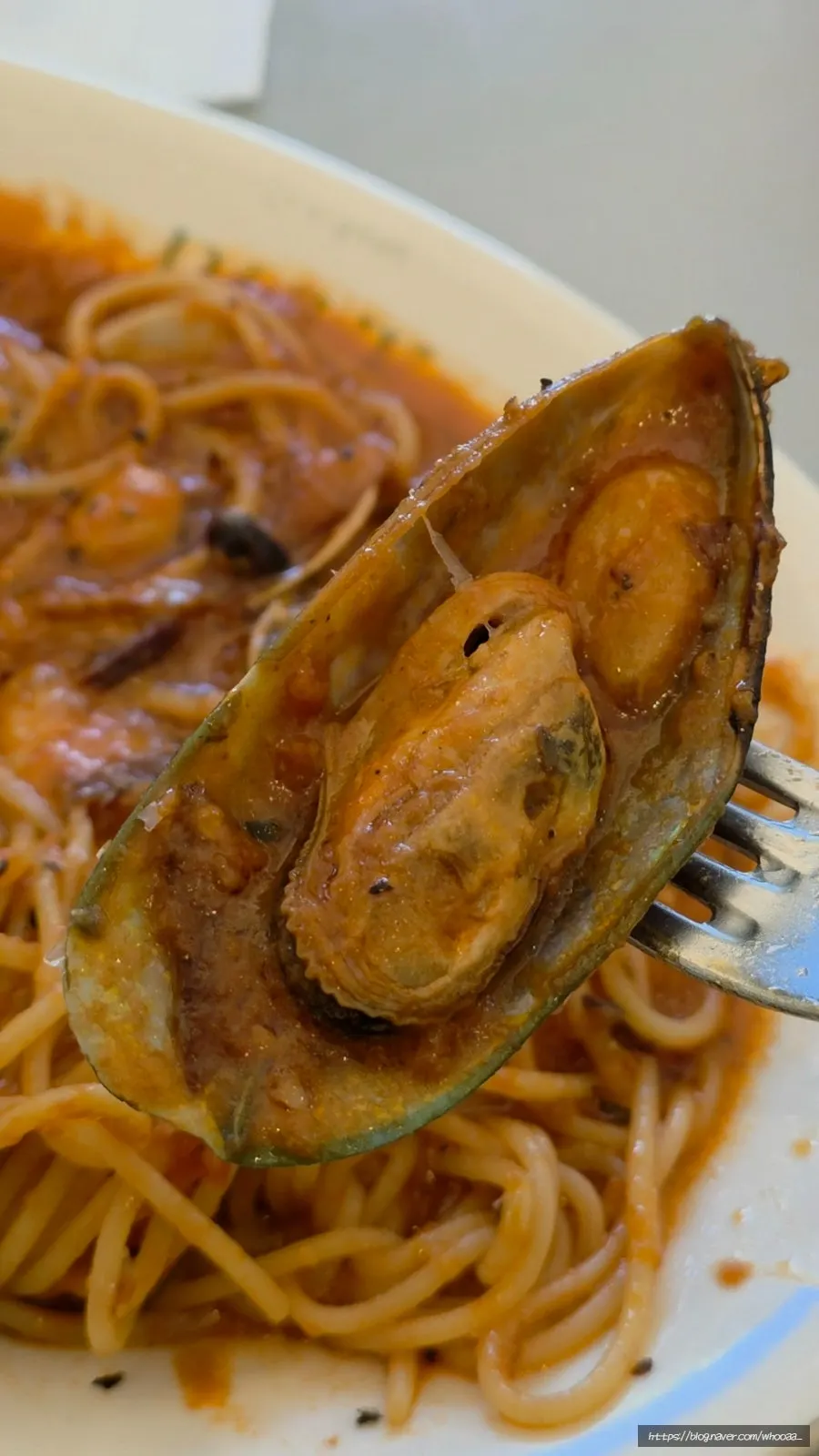 A plate of seafood tomato pasta