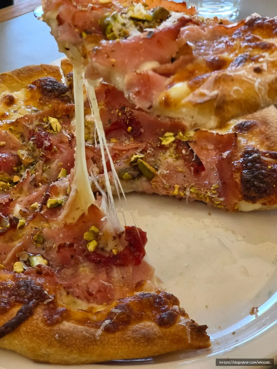 A slice of thin-crust jambon wood-fired pizza