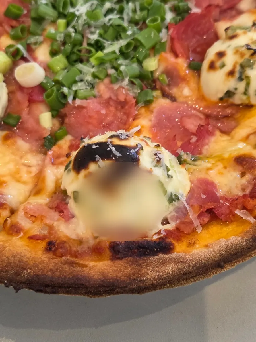 Close-up of pizza topped with jambon and chives
