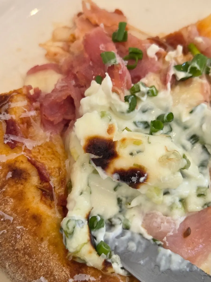 A pizza slice drizzled with honey