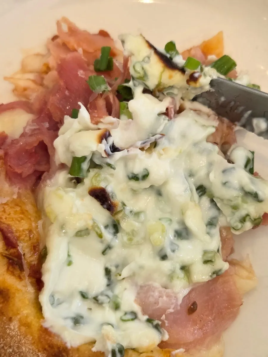 Crust end of the pizza dipped in cream cheese