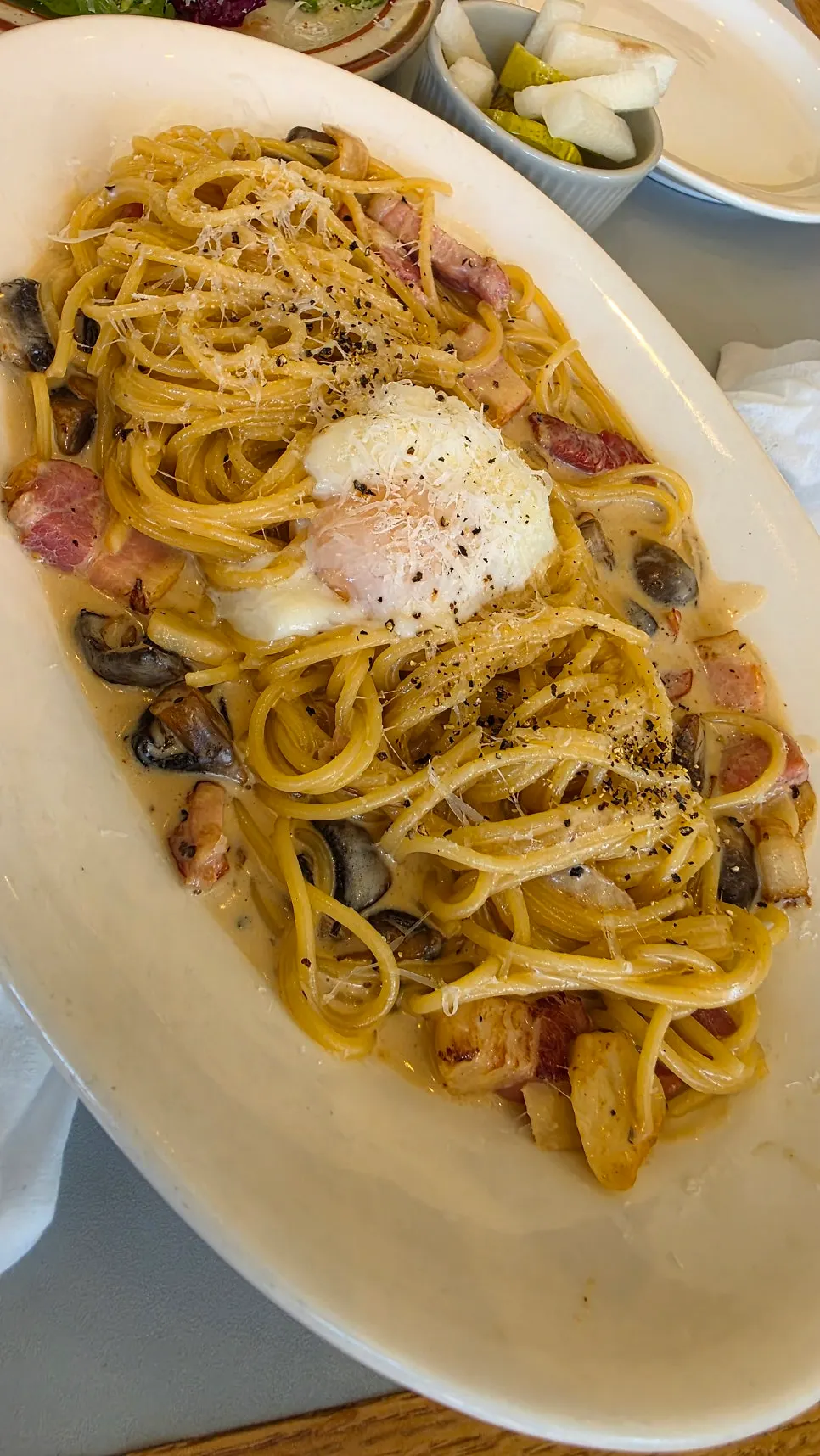 Carbonara topped with an egg yolk