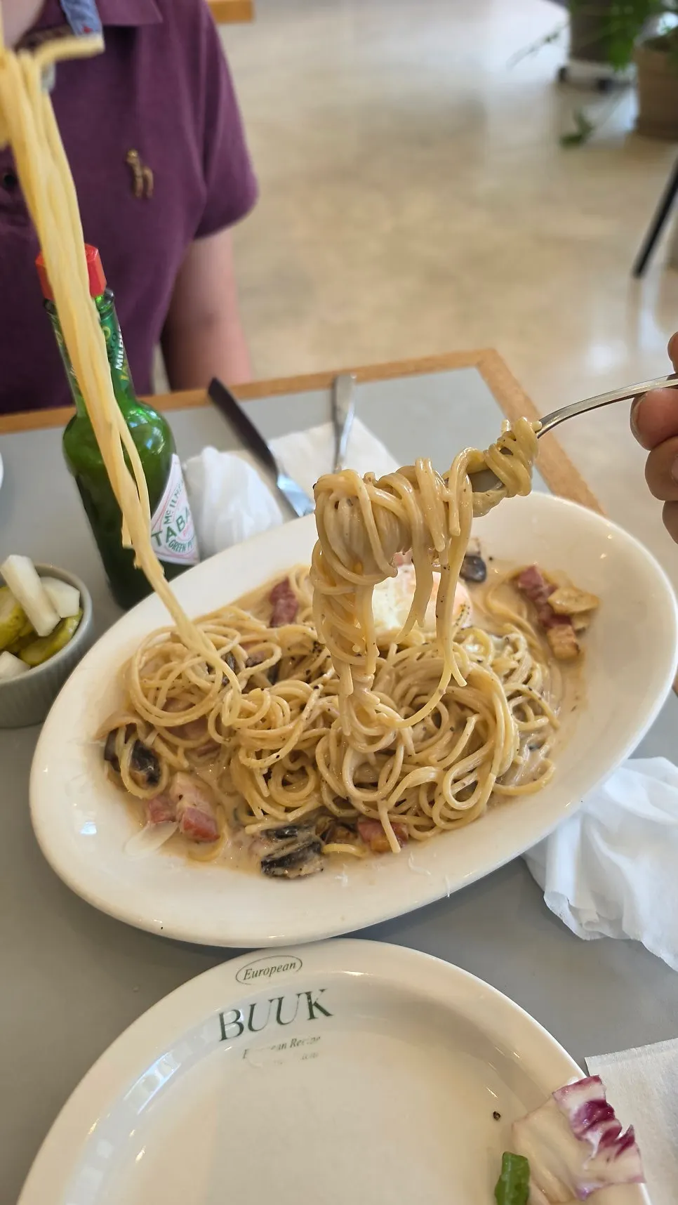 Cream pasta noodles twirled on a fork