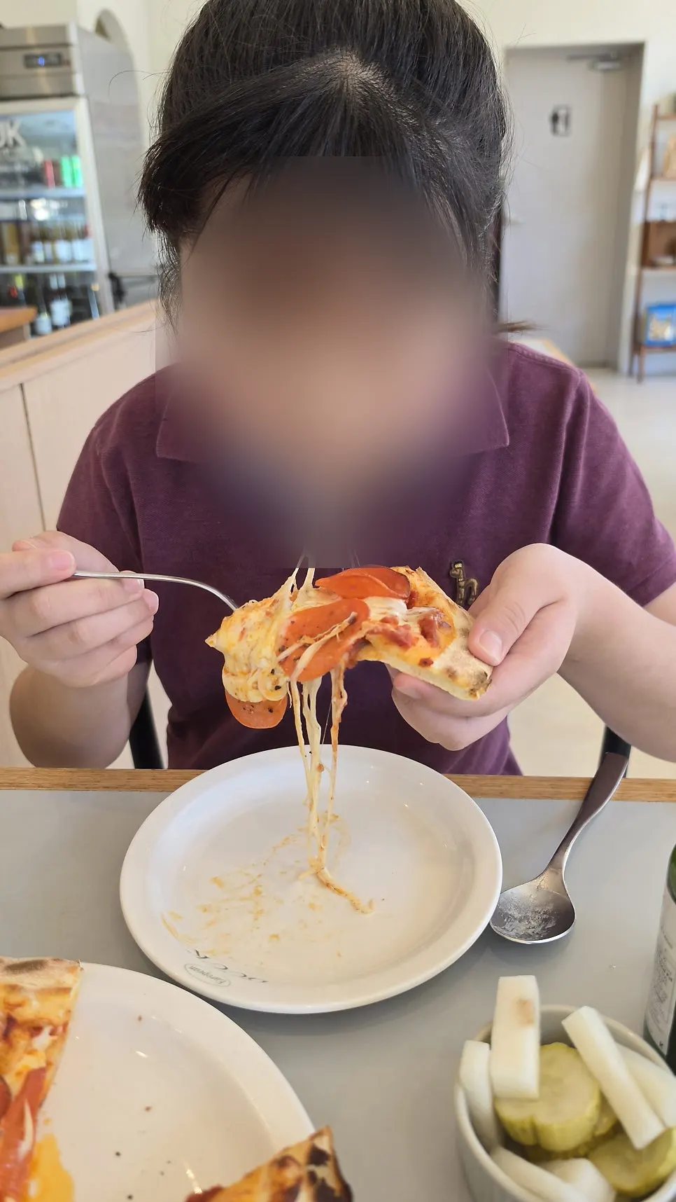 Cheese stretching as a pizza slice is lifted