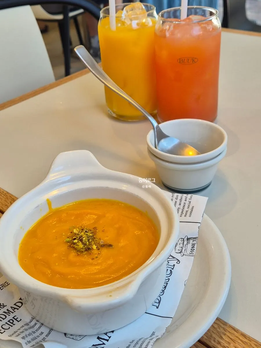 Pumpkin soup and a drink placed on the table