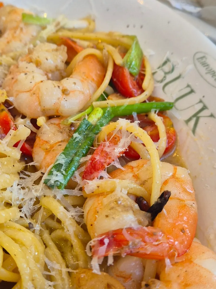 Close-up of oil pasta topped with shrimp