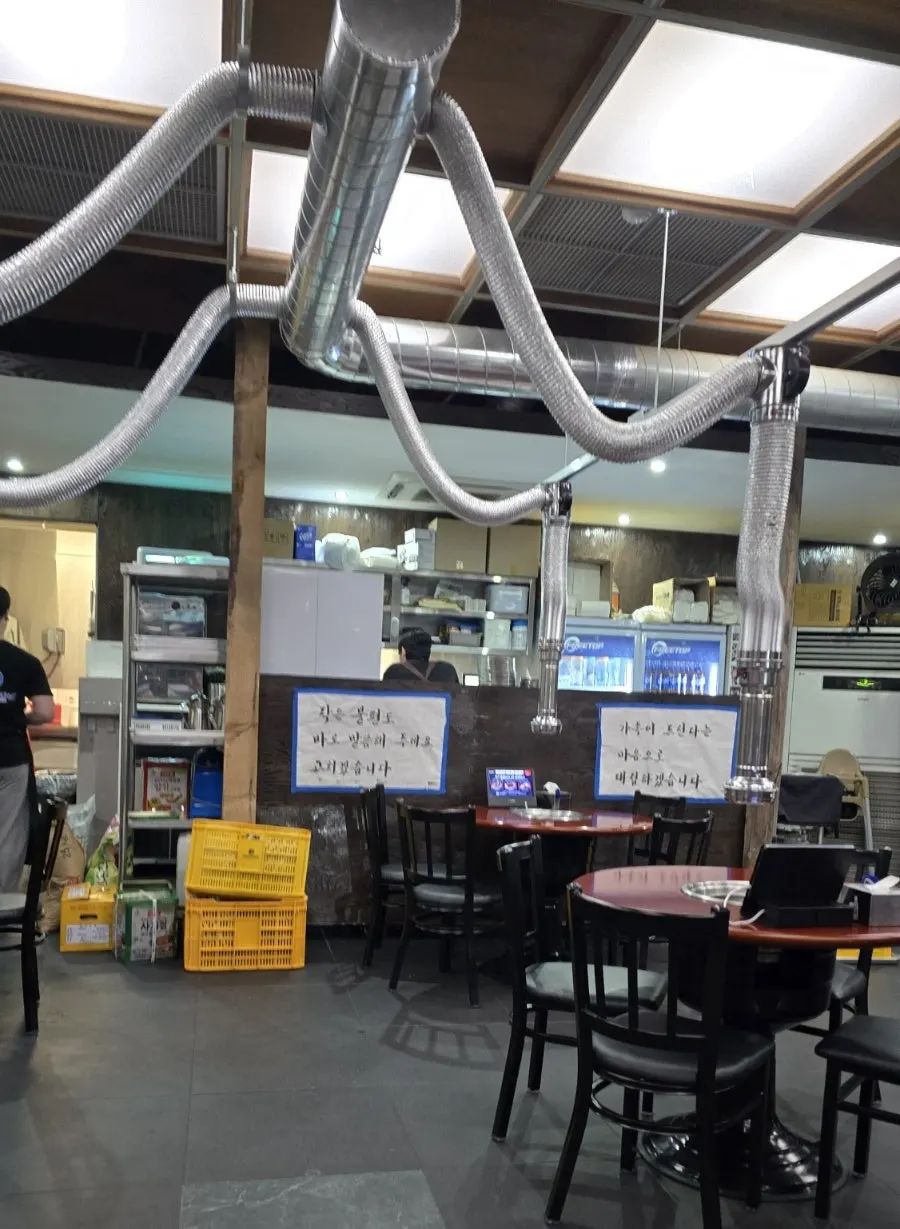 Spacious restaurant interior with ceiling ventilation system installed