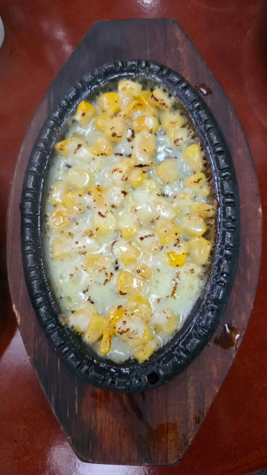 Basic side dishes with complimentary doenjang jjigae and stone pot corn cheese