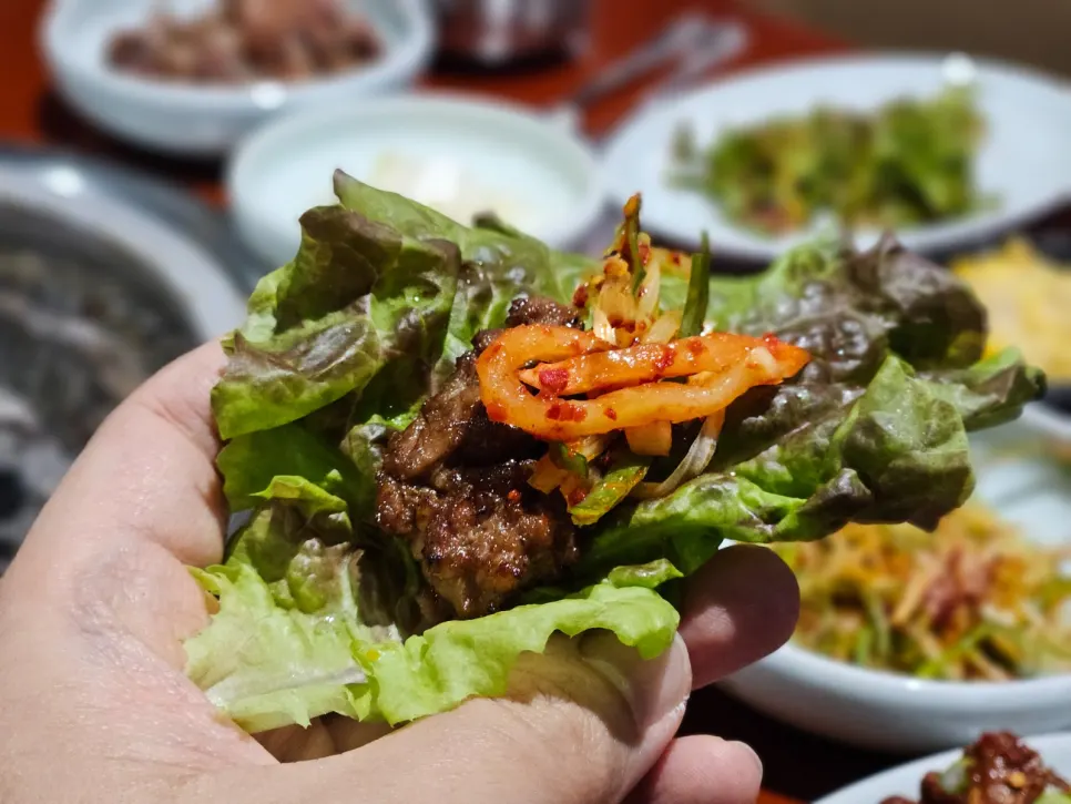 Seasoned galbi being flipped frequently while grilling