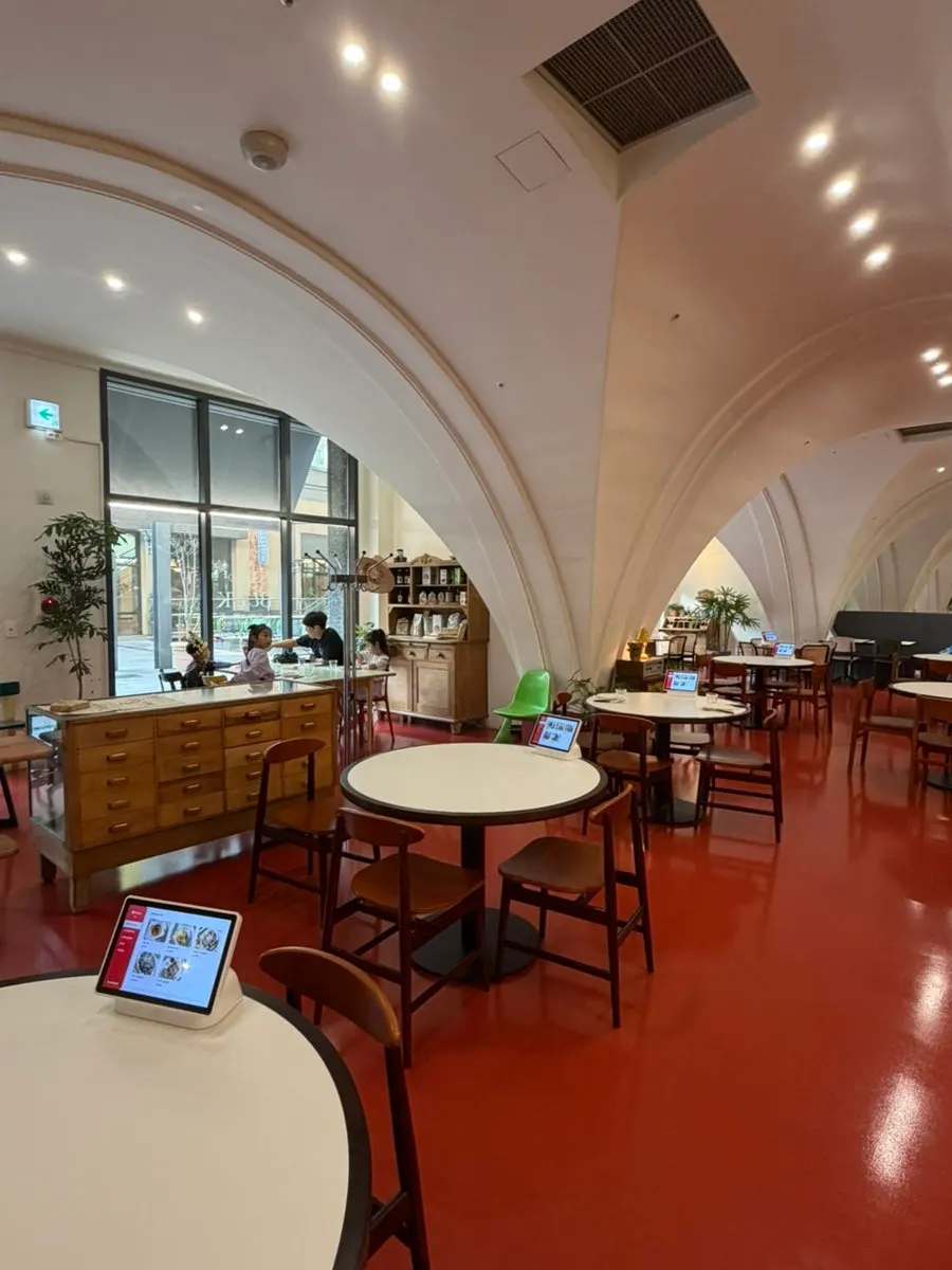 View of the restaurant with round tables and colorful chairs
