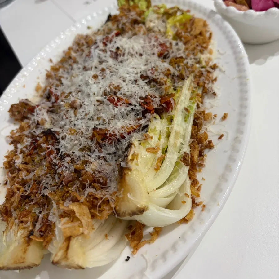 A plate of napa cabbage Caesar salad