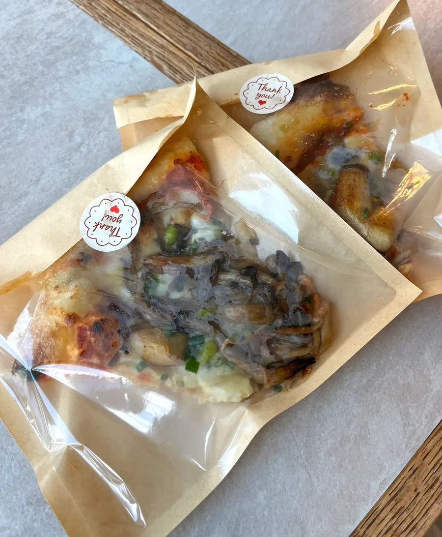 Two remaining slices of truffle mushroom pizza