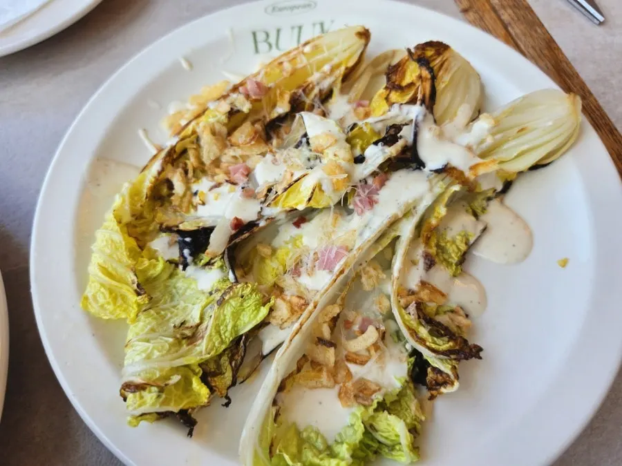 Grilled napa cabbage with Caesar dressing on a plate