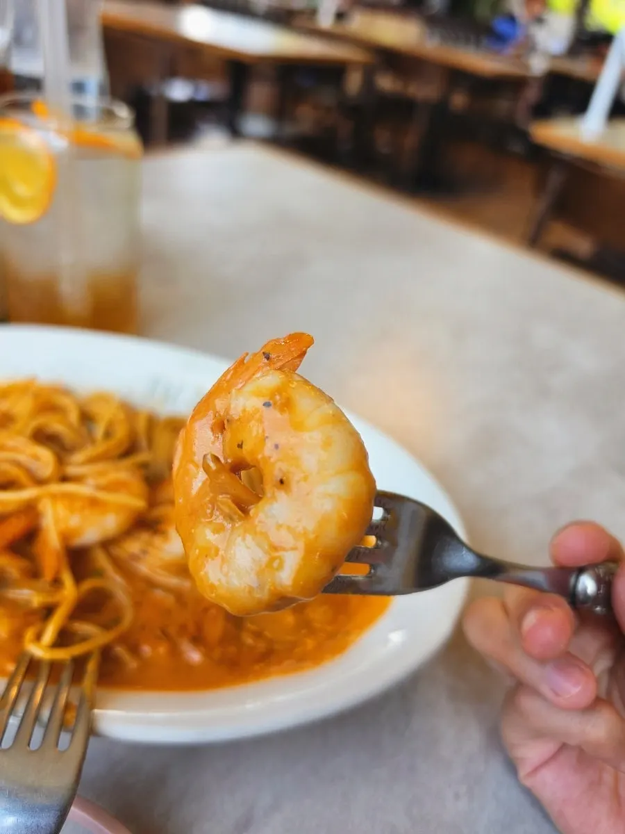 A bite of noodles twirled in rosé sauce