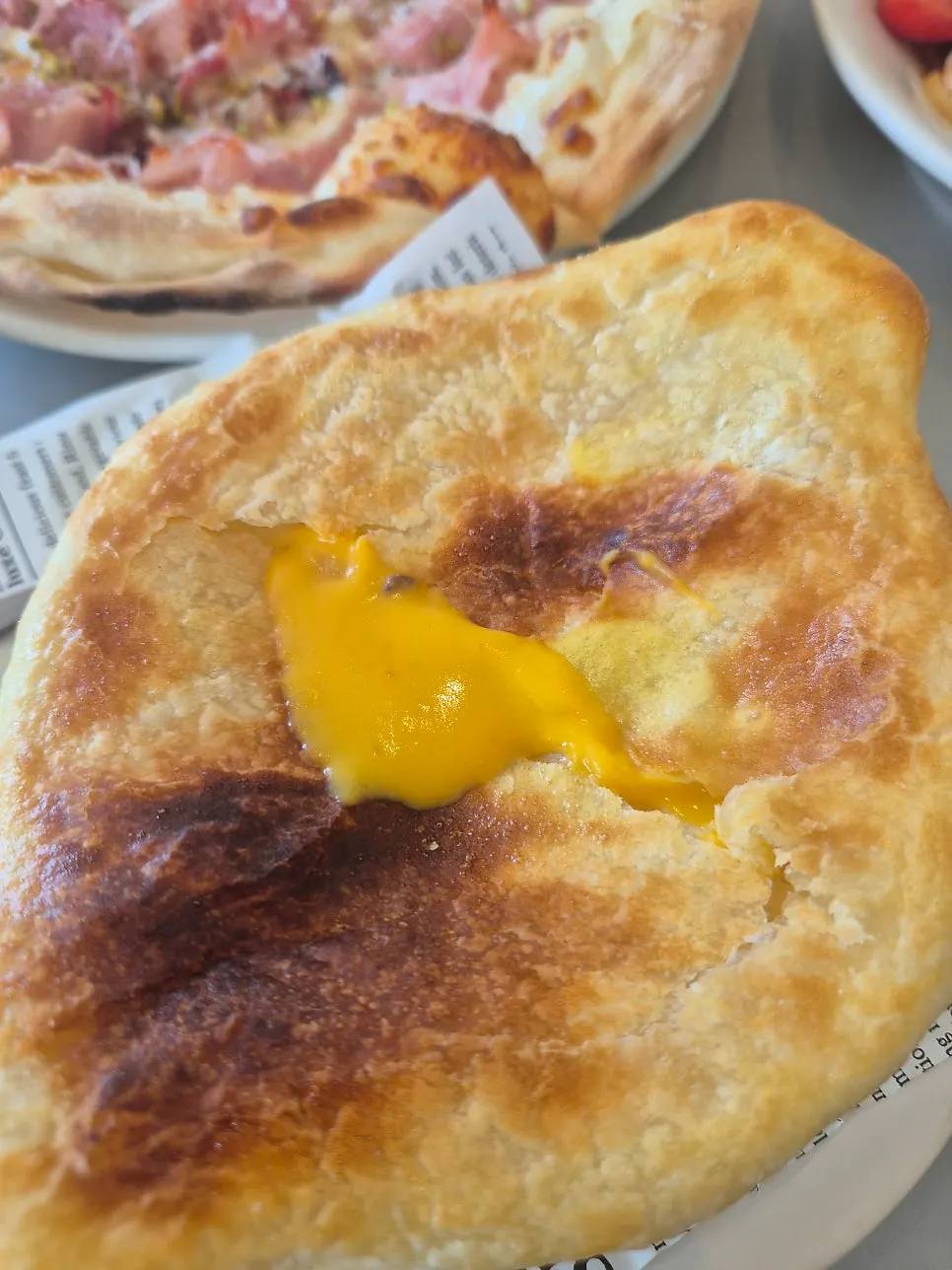 A bowl of pumpkin soup topped with pastry
