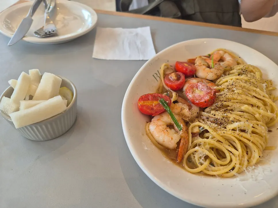 Plate of oil pasta with visible cherry tomatoes
