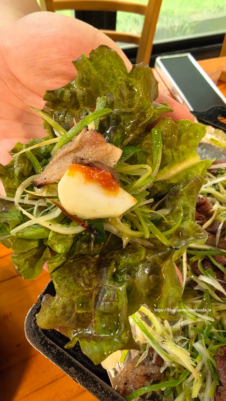 A piece of bulgogi dipped in sauce