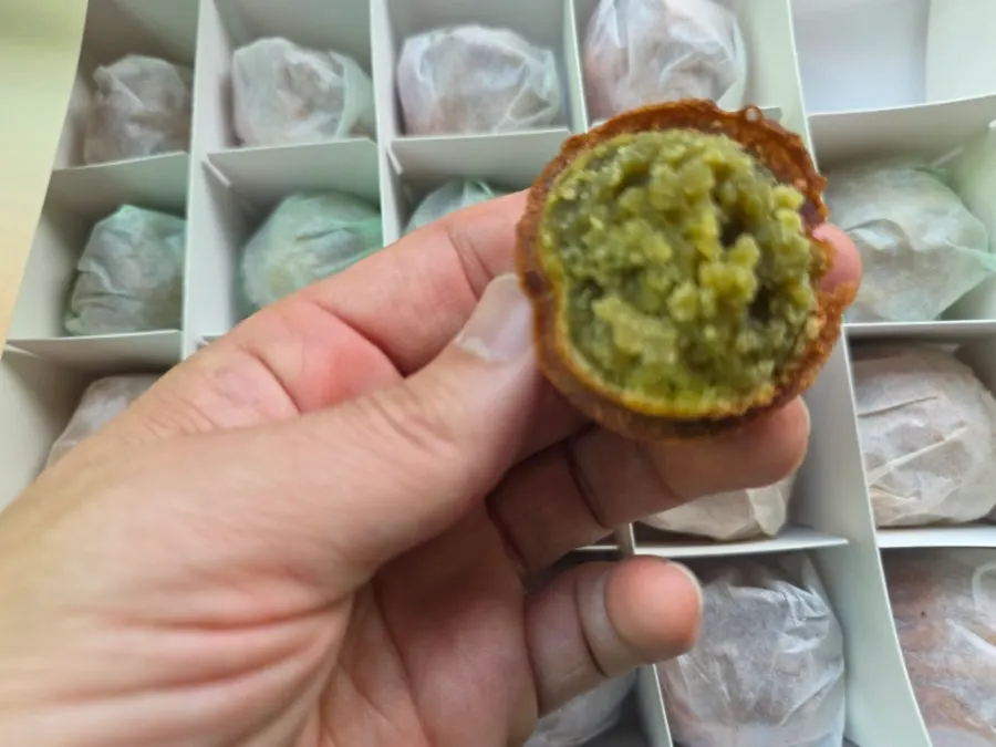 Inside the box: 24 walnut pastries individually wrapped in glassine paper